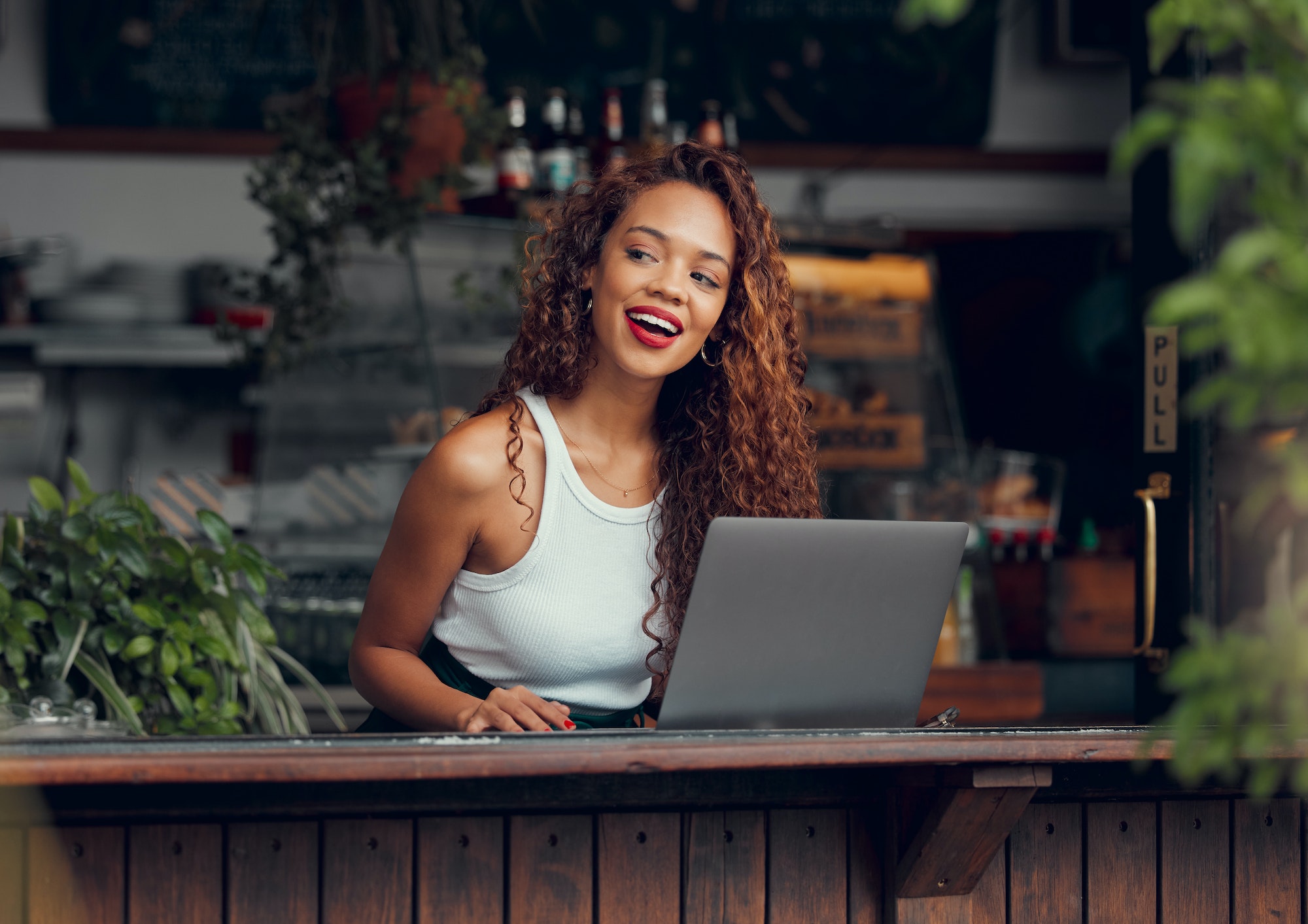 Woman, laptop and ideas in coffee shop, restaurant or Brazilian cafe for remote work, blog writing